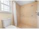 Bathroom featuring a fully tiled shower with a tiled floor and a toilet at 2871 Milstead St, Orlando, FL 32837