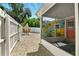 The backyard features a screened patio, dining set, and gravel landscaping for low maintenance at 318 Palm St, New Smyrna Beach, FL 32168