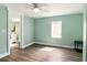 Bedroom with wood look vinyl floors and access to bathroom at 318 Palm St, New Smyrna Beach, FL 32168