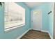 Entryway features wood look vinyl flooring and a window with blinds at 318 Palm St, New Smyrna Beach, FL 32168