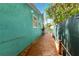 View of wooden deck along side of brightly painted home with white fencing at 318 Palm St, New Smyrna Beach, FL 32168