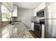 Well-lit kitchen features granite countertops and stainless steel appliances at 318 Palm St, New Smyrna Beach, FL 32168