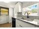 Bright kitchen featuring granite countertops, stainless steel sink, and tile backsplash at 318 Palm St, New Smyrna Beach, FL 32168