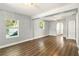 Bright living room with laminate floors, neutral walls, and multiple windows at 318 Palm St, New Smyrna Beach, FL 32168