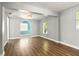 Inviting living room with laminate floors, neutral walls, and archway to adjacent room at 318 Palm St, New Smyrna Beach, FL 32168