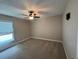 Bedroom with a ceiling fan, window, and neutral-colored walls and carpet at 358 2Nd St, Geneva, FL 32732