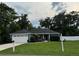 Charming home with a well-manicured lawn, lush landscaping, and a two-car garage at 358 2Nd St, Geneva, FL 32732