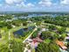 Expansive aerial view of a lakeside home with a well-manicured golf course at 3637 Dubsdread Cir, Orlando, FL 32804