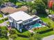 Modern home with pool, sleek design, outdoor lounge, surrounded by lush landscaping at 3637 Dubsdread Cir, Orlando, FL 32804