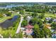 Expansive aerial view of a home near a lake and golf course, showcasing lush greenery and the surrounding landscape at 3637 Dubsdread Cir, Orlando, FL 32804