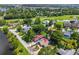 Aerial view of residential area with mature trees and greenery near a golf course and small pond at 3637 Dubsdread Cir, Orlando, FL 32804