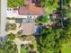 Aerial view of landscaped home, featuring unique roof, mature trees and outdoor spaces at 3637 Dubsdread Cir, Orlando, FL 32804