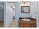 Cozy bathroom featuring a wood vanity with blue tile, and an ornate mirror and lighting fixtures at 3637 Dubsdread Cir, Orlando, FL 32804