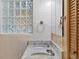 Bathroom featuring double vanity, glass block window, and updated finishes at 3637 Dubsdread Cir, Orlando, FL 32804