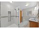 Bathroom with a glass-enclosed shower, double sinks, and modern fixtures at 3637 Dubsdread Cir, Orlando, FL 32804