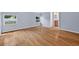 Serene bedroom with hardwood floors, two bright windows, and an ensuite bathroom at 3637 Dubsdread Cir, Orlando, FL 32804