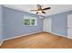Bedroom with wood floors, ceiling fan and natural light from the window at 3637 Dubsdread Cir, Orlando, FL 32804