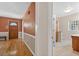Hallway featuring a front door and access to a brightly lit bathroom at 3637 Dubsdread Cir, Orlando, FL 32804