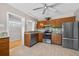 This updated kitchen boasts stainless appliances, granite counters and wooden cabinetry at 3637 Dubsdread Cir, Orlando, FL 32804