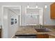 Kitchen featuring granite countertops, wooden cabinets, and a stainless steel sink, blending style and functionality at 3637 Dubsdread Cir, Orlando, FL 32804