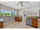 Bright kitchen with granite countertops, stainless steel appliances, wooden cabinets, and a window offering natural light at 3637 Dubsdread Cir, Orlando, FL 32804