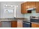 This kitchen is equipped with stainless steel appliances, granite countertops, and bright, modern lighting at 3637 Dubsdread Cir, Orlando, FL 32804