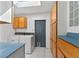 Laundry room featuring a washer and dryer set, ample cabinet space, and a bright skylight, offering convenience and storage at 3637 Dubsdread Cir, Orlando, FL 32804