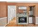 Inviting living room with a decorative stone fireplace, hardwood flooring, and built-in shelving at 3637 Dubsdread Cir, Orlando, FL 32804