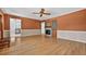 Spacious living room boasts hardwood floors and a cozy stone fireplace feature at 3637 Dubsdread Cir, Orlando, FL 32804