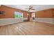 Inviting living room with hardwood floors, a ceiling fan, and natural light streaming through the window at 3637 Dubsdread Cir, Orlando, FL 32804