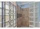 Modern shower with tan tile, glass block and mosaic accents with a decorative glass block partition at 3637 Dubsdread Cir, Orlando, FL 32804