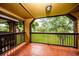 Balcony with tiled floor and brown railing offering views of the trees and lawn at 420 Forestway Cir # 306, Altamonte Springs, FL 32701