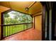 The balcony offers an outdoor space with brown railings and tiled floor with views of trees and lawn at 420 Forestway Cir # 306, Altamonte Springs, FL 32701