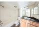 Bathroom with vanity and shower-tub combo features white tiles, and a granite-style counter at 420 Forestway Cir # 306, Altamonte Springs, FL 32701