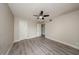 An empty bedroom with wood-style floors and multiple doors to closets and other rooms at 420 Forestway Cir # 306, Altamonte Springs, FL 32701