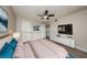 This virtually staged bedroom offers wood-style flooring, a ceiling fan and a television at 420 Forestway Cir # 306, Altamonte Springs, FL 32701