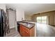 An open kitchen featuring stainless steel sink and appliances, next to a living area with sliding glass doors at 420 Forestway Cir # 306, Altamonte Springs, FL 32701