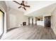 Bright living room with wood-look floors, fireplace, ceiling fan, and sliding glass doors to balcony at 420 Forestway Cir # 306, Altamonte Springs, FL 32701