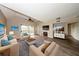 Stylishly staged living room showcasing vaulted ceilings, modern furniture, fireplace, and seamless access to the balcony at 420 Forestway Cir # 306, Altamonte Springs, FL 32701
