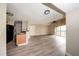 Bright living room featuring wood-look floors, ceiling fan and sliding glass door to balcony for seamless indoor-outdoor living at 420 Forestway Cir # 306, Altamonte Springs, FL 32701