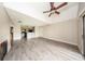 Inviting open-concept living room with high ceilings, ceiling fan, wood-look floors, and easy access to the kitchen at 420 Forestway Cir # 306, Altamonte Springs, FL 32701