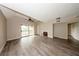 Spacious living room boasting vaulted ceiling, ceiling fan, fireplace and wood-look floors, with balcony access at 420 Forestway Cir # 306, Altamonte Springs, FL 32701