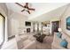 Comfortable staged living room with fireplace and wood-look floors, flowing seamlessly into kitchen at 420 Forestway Cir # 306, Altamonte Springs, FL 32701
