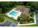 Aerial view of community pool surrounded by trees, landscaping, and parking at 420 Forestway Cir # 306, Altamonte Springs, FL 32701