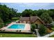 Community pool and spa surrounded by trees and landscaping at 420 Forestway Cir # 306, Altamonte Springs, FL 32701