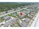 Aerial view of home situated among beachfront residences with mature landscaping and community tennis courts at 4365 S Atlantic Ave # B8, New Smyrna Beach, FL 32169
