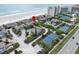 Breathtaking aerial view of a beachfront property near tennis courts and sandy shoreline at 4365 S Atlantic Ave # B8, New Smyrna Beach, FL 32169