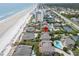 Aerial view of homes with direct beach access, a pool, and blue ocean at 4365 S Atlantic Ave # B8, New Smyrna Beach, FL 32169