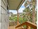 Private balcony with verdant views of palms, landscape, and neighboring building at 4365 S Atlantic Ave # B8, New Smyrna Beach, FL 32169