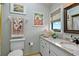 Well-lit bathroom with granite counters, decorative accents, and an artful arrangement at 4365 S Atlantic Ave # B8, New Smyrna Beach, FL 32169
